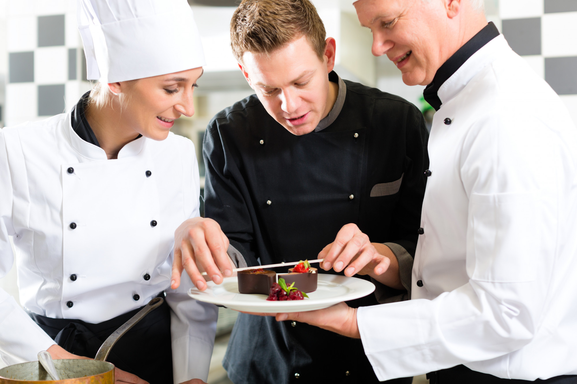 Instructor demonstrating plating technique to a small group